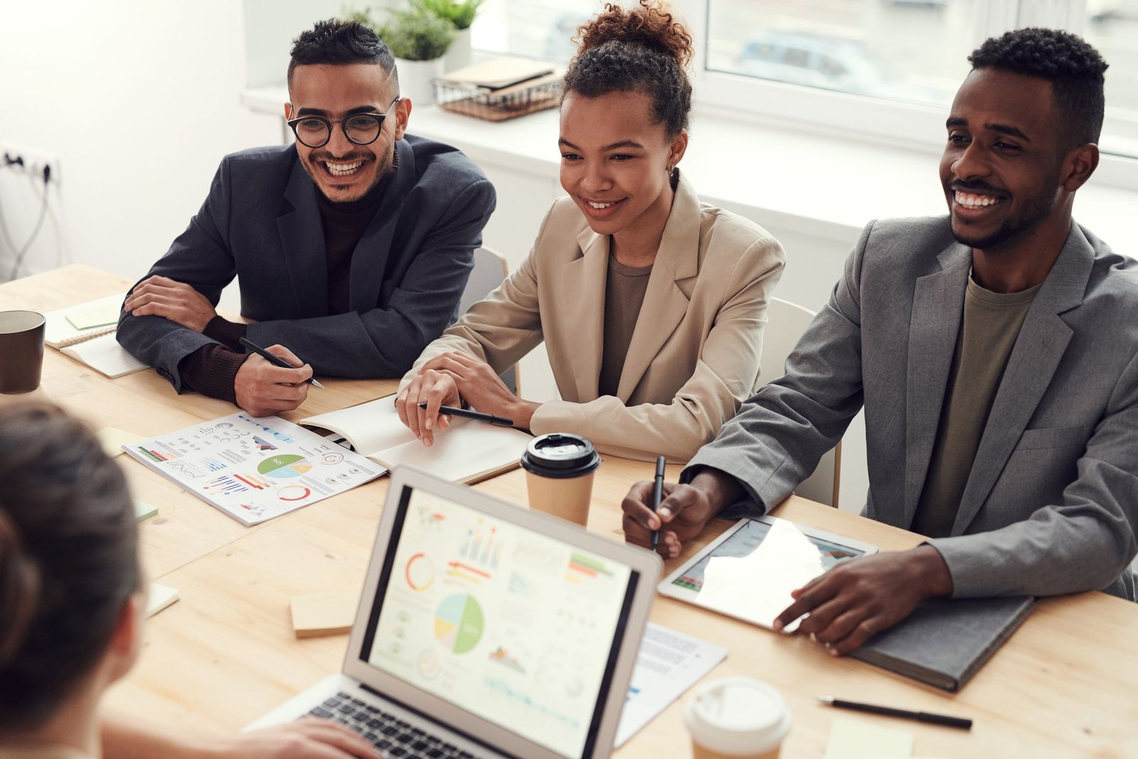 Équipe souriante de collaborateurs en réunion de travail